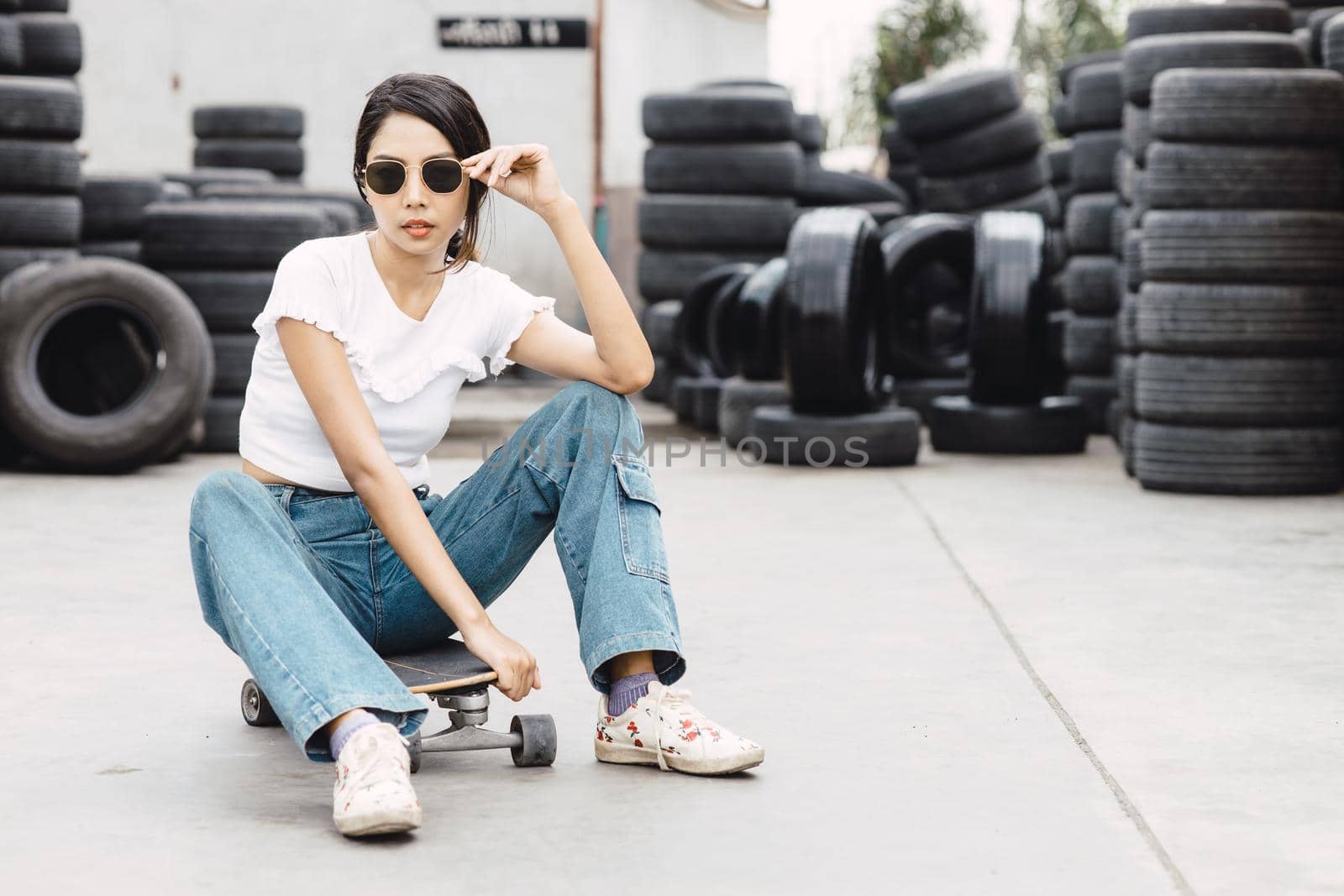 Asian young teen,  modern teenager girl, gen z hipster women with skateboard or surfboard by qualitystocks