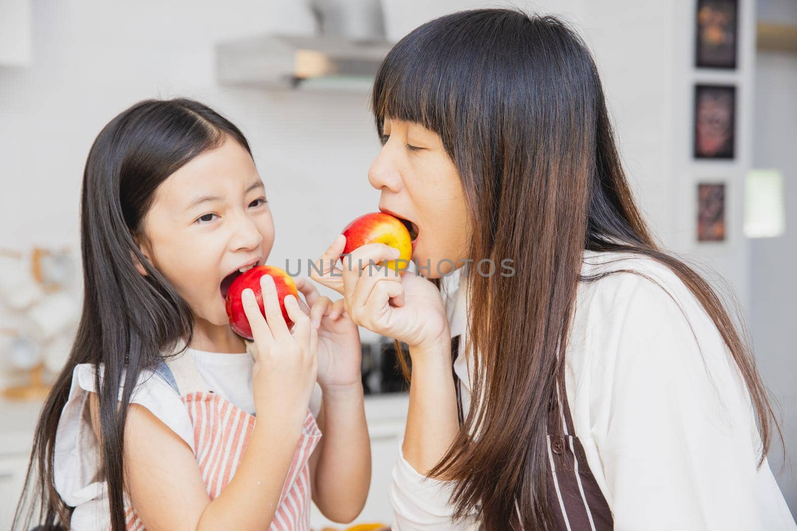 People enjoy eating apple fruits for healthy lifestyle at home with children.