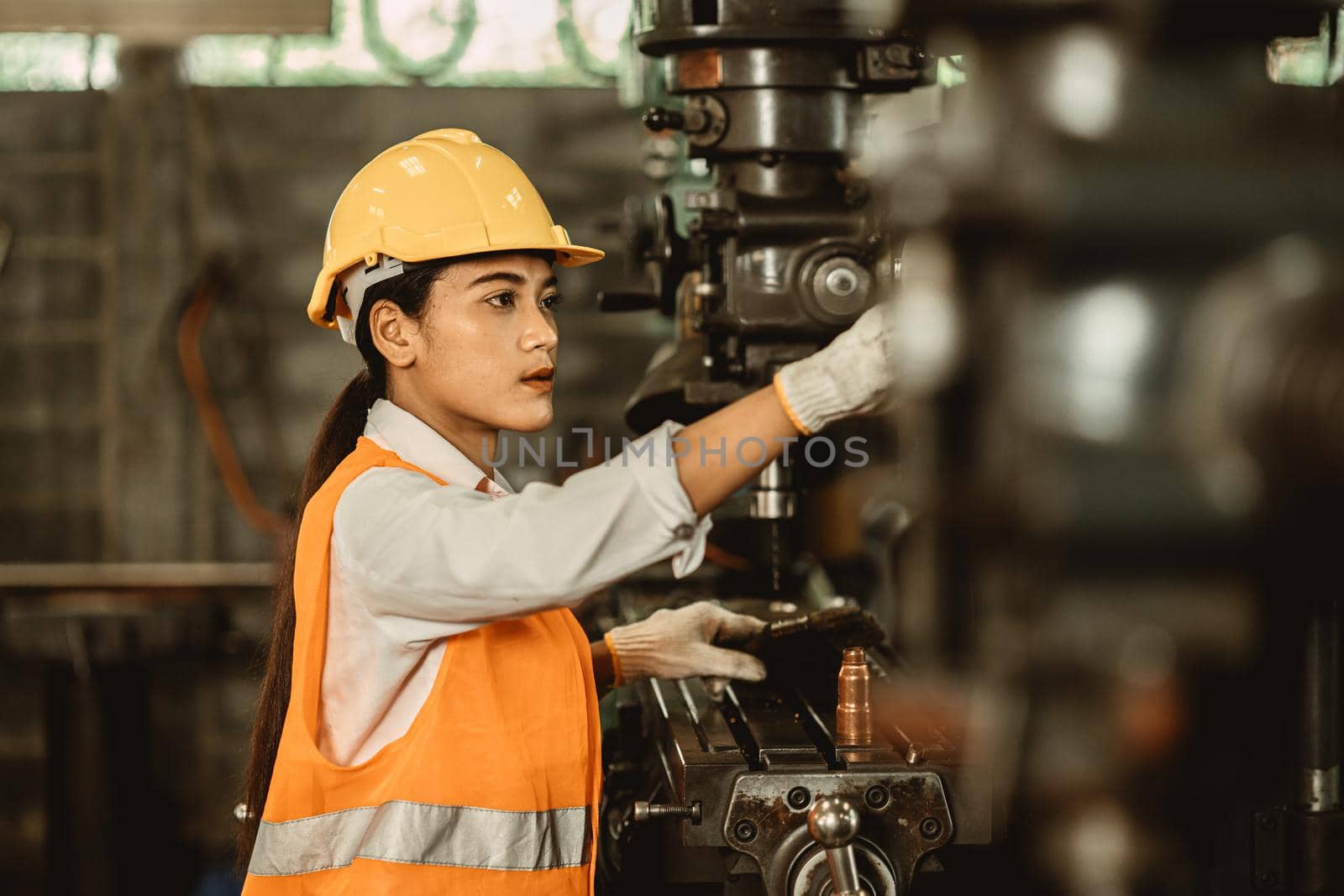 Young female women attend worker happy working in metal factory workplace work engineer fix maintenance heavy industry machine. by qualitystocks