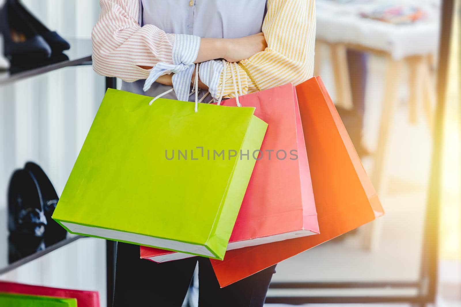 many shopping bag at fashion girl hand in shopping mall. by qualitystocks