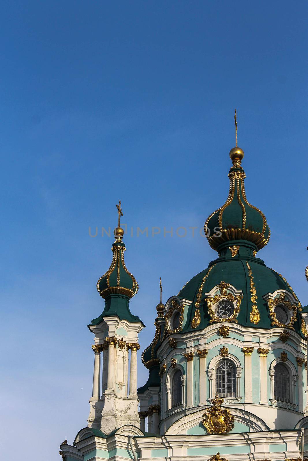 Green domes of the Kiev-Pechersk Lavra church against the blue sky by grekoni