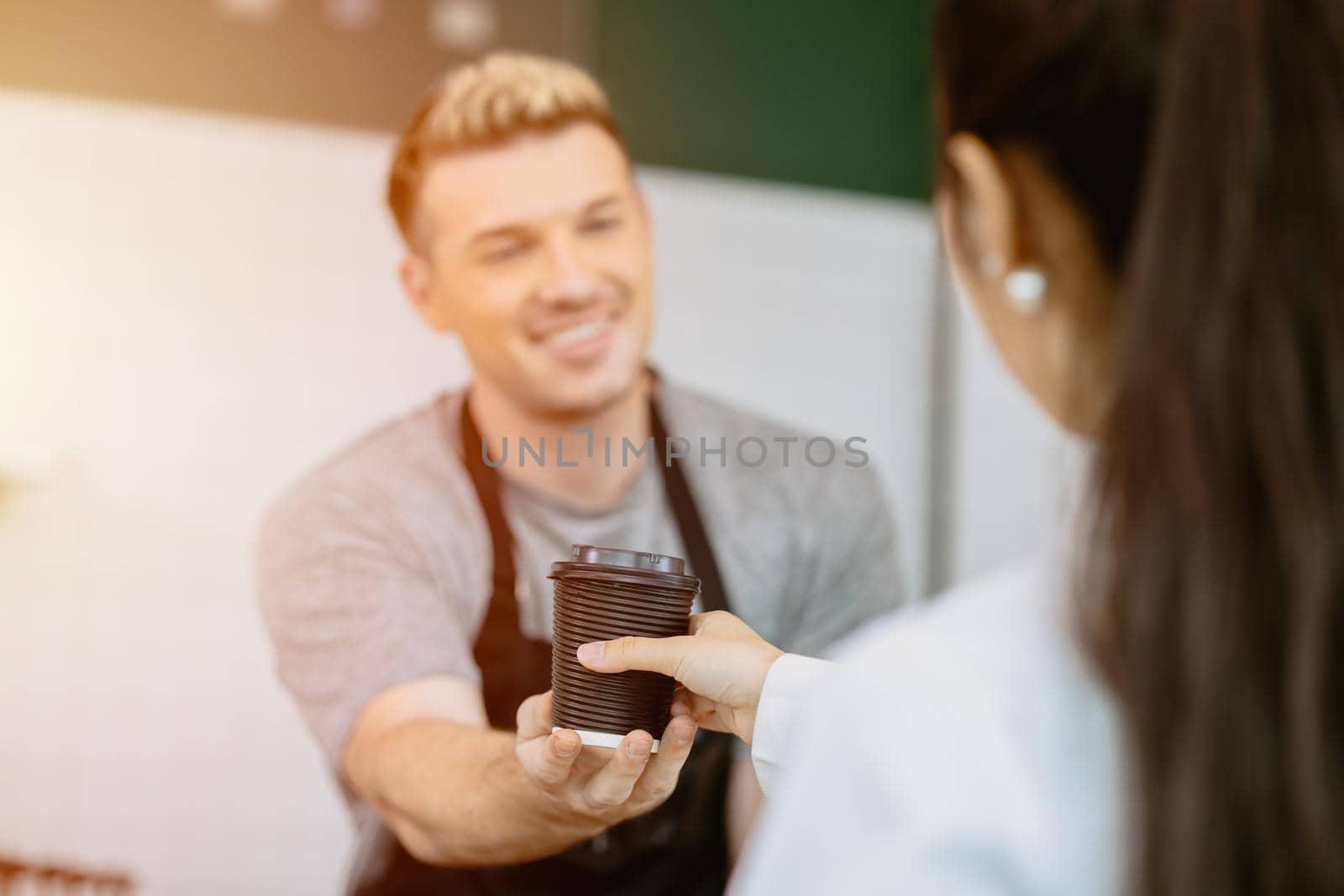 barista serve the coffee at the counter to customer with service mind happy and smile by qualitystocks