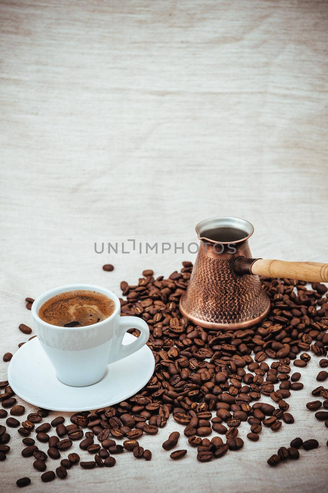 Coffee turk and cup of coffee on burlap background. coffee beans isolated on white background. roasted coffee beans by Andrii_Ko