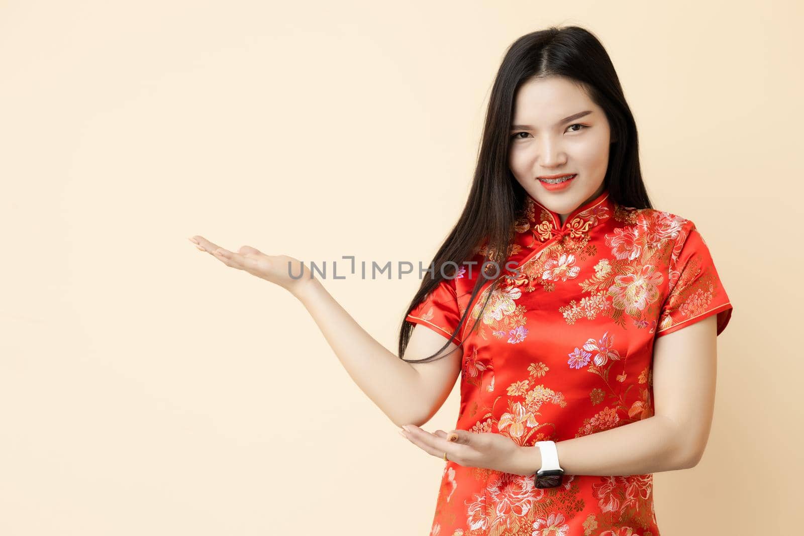 Asian Chinese teen girl hand show display presentation sale promotion posture dressing Qipao traditional cloth.