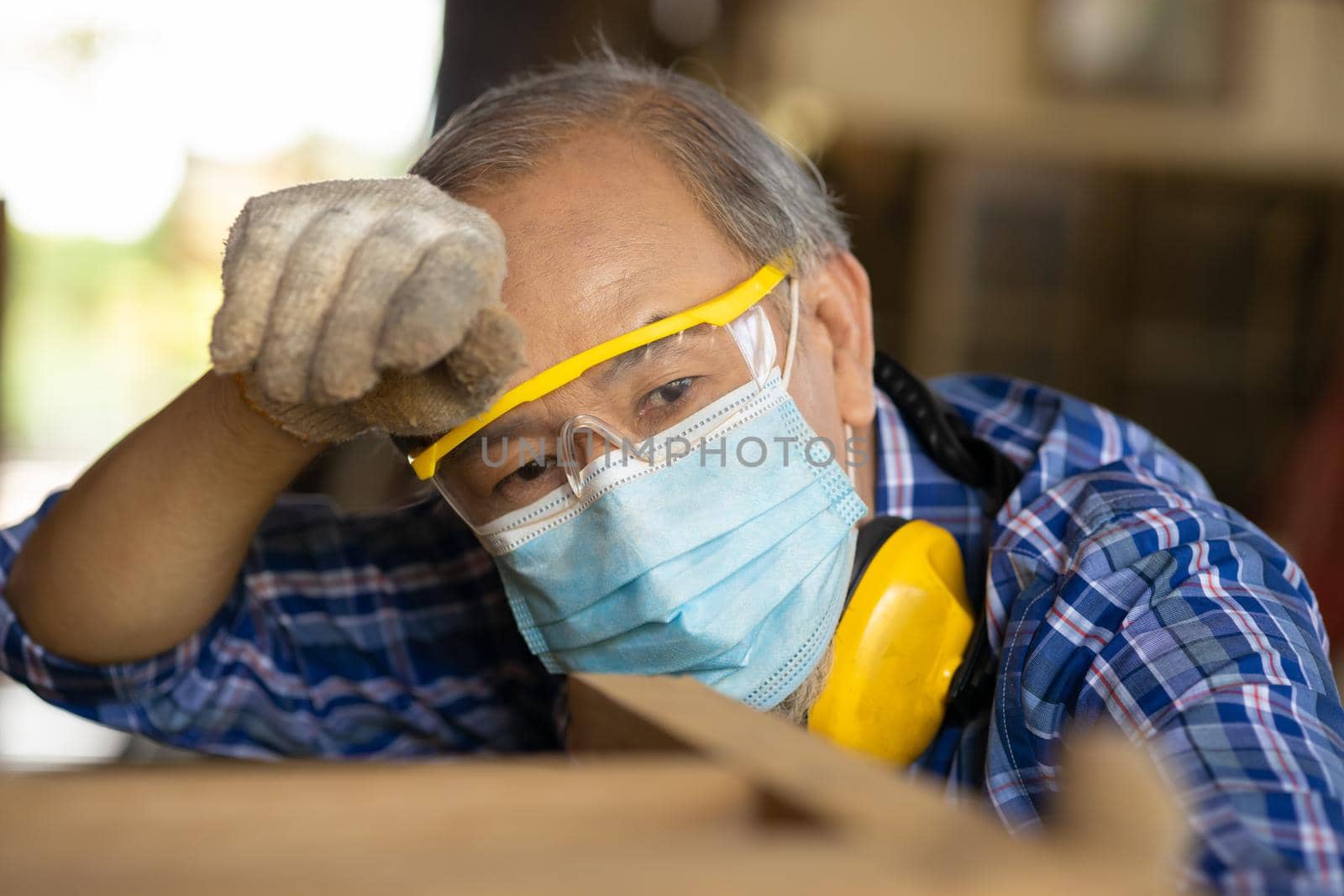 Tired exhausted elder Asian labor hard work in hot place wiping head sweat waring face mask for COVID-19 and dust protective. by qualitystocks