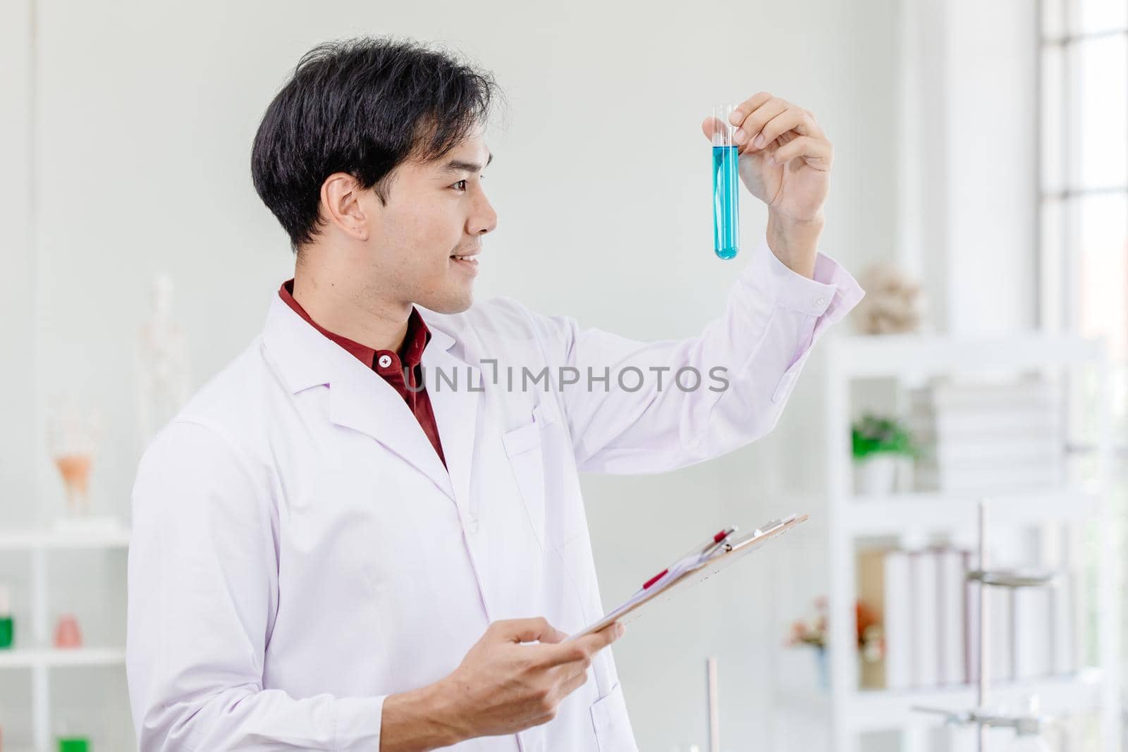 Scientists happy smile for successful discover  chemical formula develop to new drug in medical laboratory concept. by qualitystocks