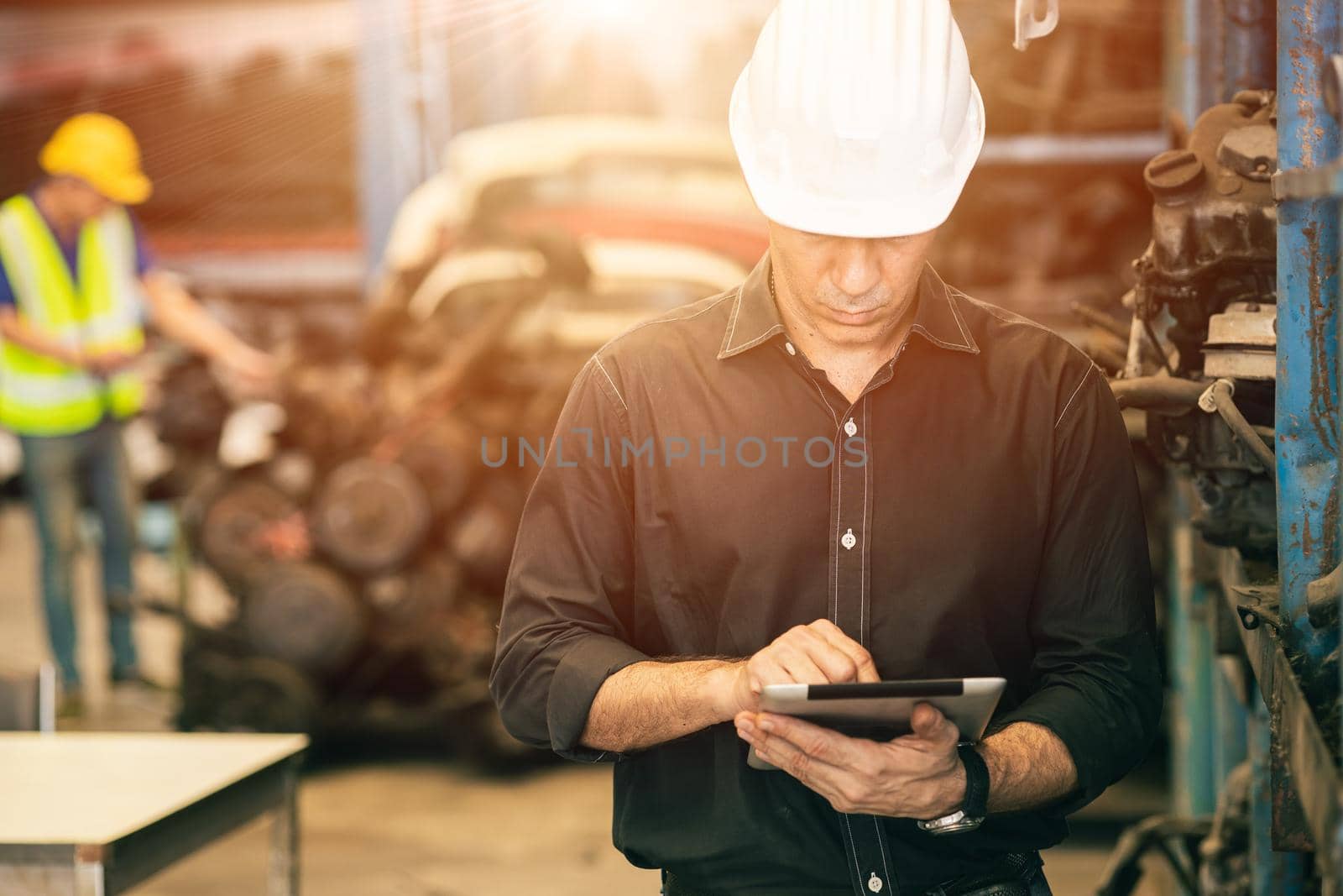 Professional adult Engineer male attending duty work in factory working checking stock inventory data with tablet computer by qualitystocks
