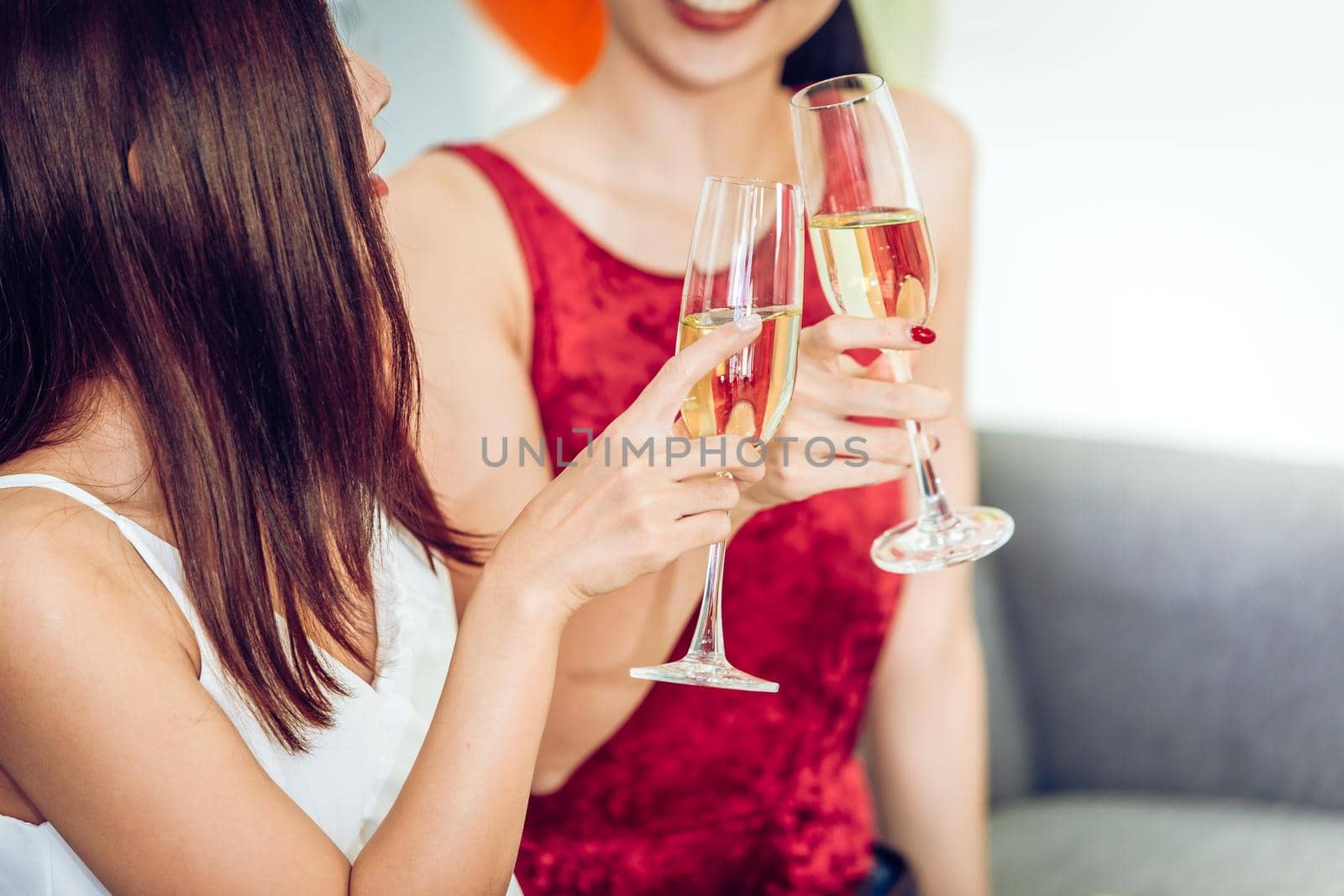 Women happy drinking white wine or champagne talking with friend enjoy together in party.