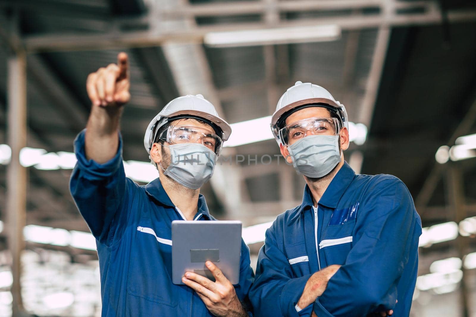 Engineer worker men teamwork wear face mask during service working in factory to check prevent Covid-19 virus air dust pollution and for good healthy.