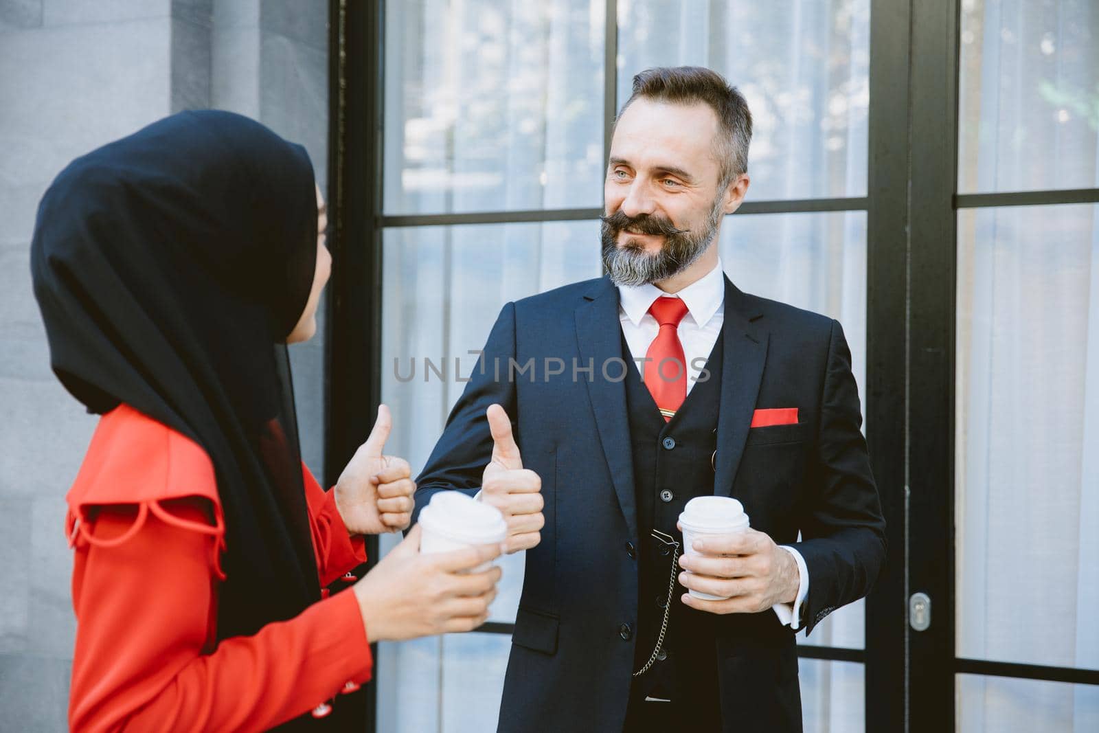 Arab Muslim Hispanic Business people working partner talking together during coffee break.