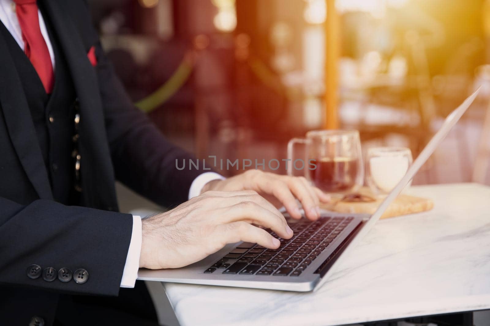 Businessman working at cafe. business male worker typing at laptop computer with coffee on the table.