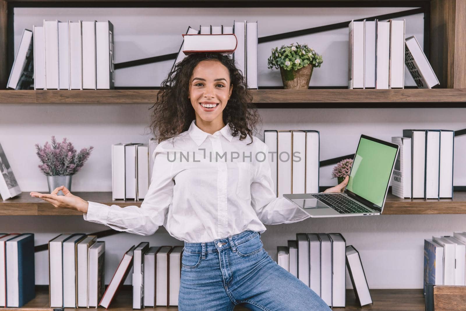 Happy fun university girl teen or business worker doing yoga in the office funny joke relax posture.