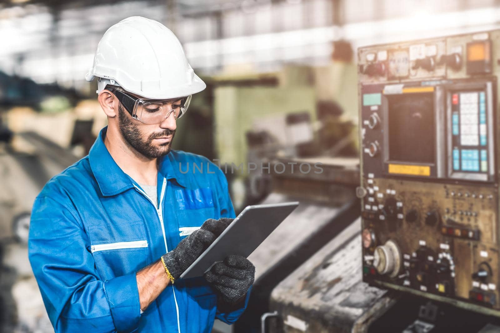 engineer setup the CNC machine with G-Code programming upload from Computer Tablet for technology in heavy industry. by qualitystocks