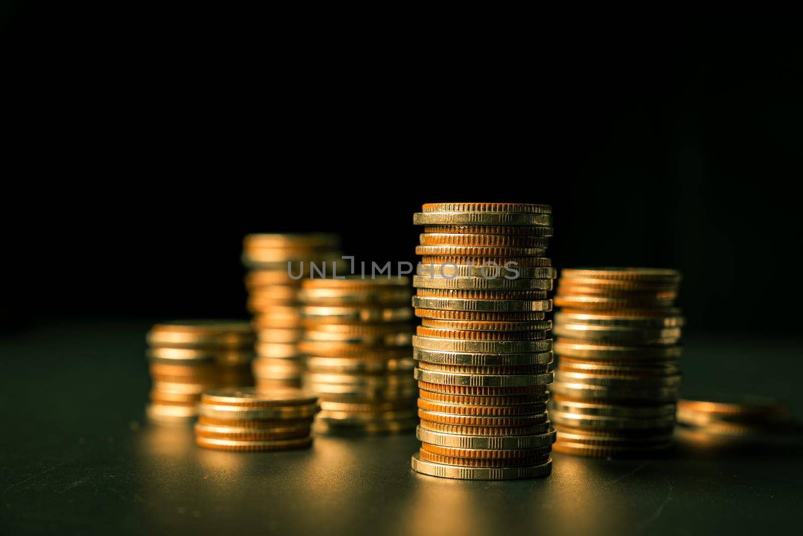 Pile of gold coins stack in finance treasury deposit bank account for saving . Concept of corporate business economy and financial growth by investment in valuable asset to gain cash revenue profit .