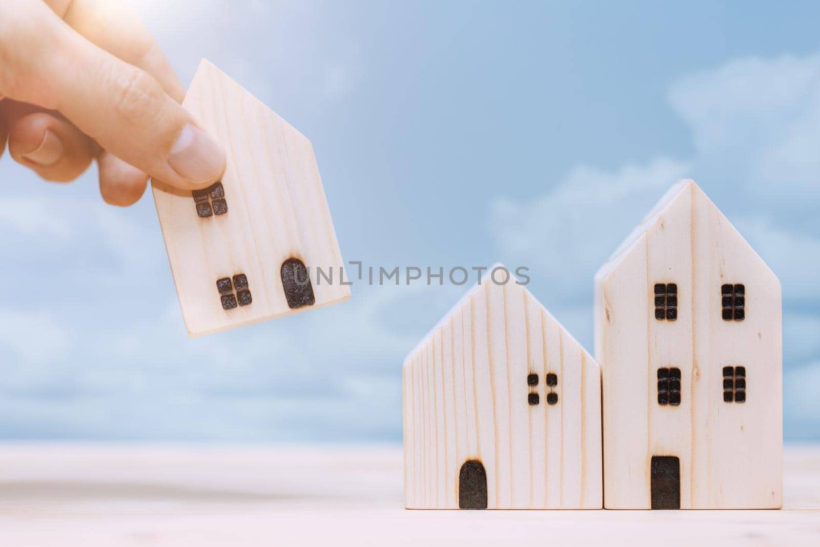 Hand placed or move home model for relocate or moving house concept.