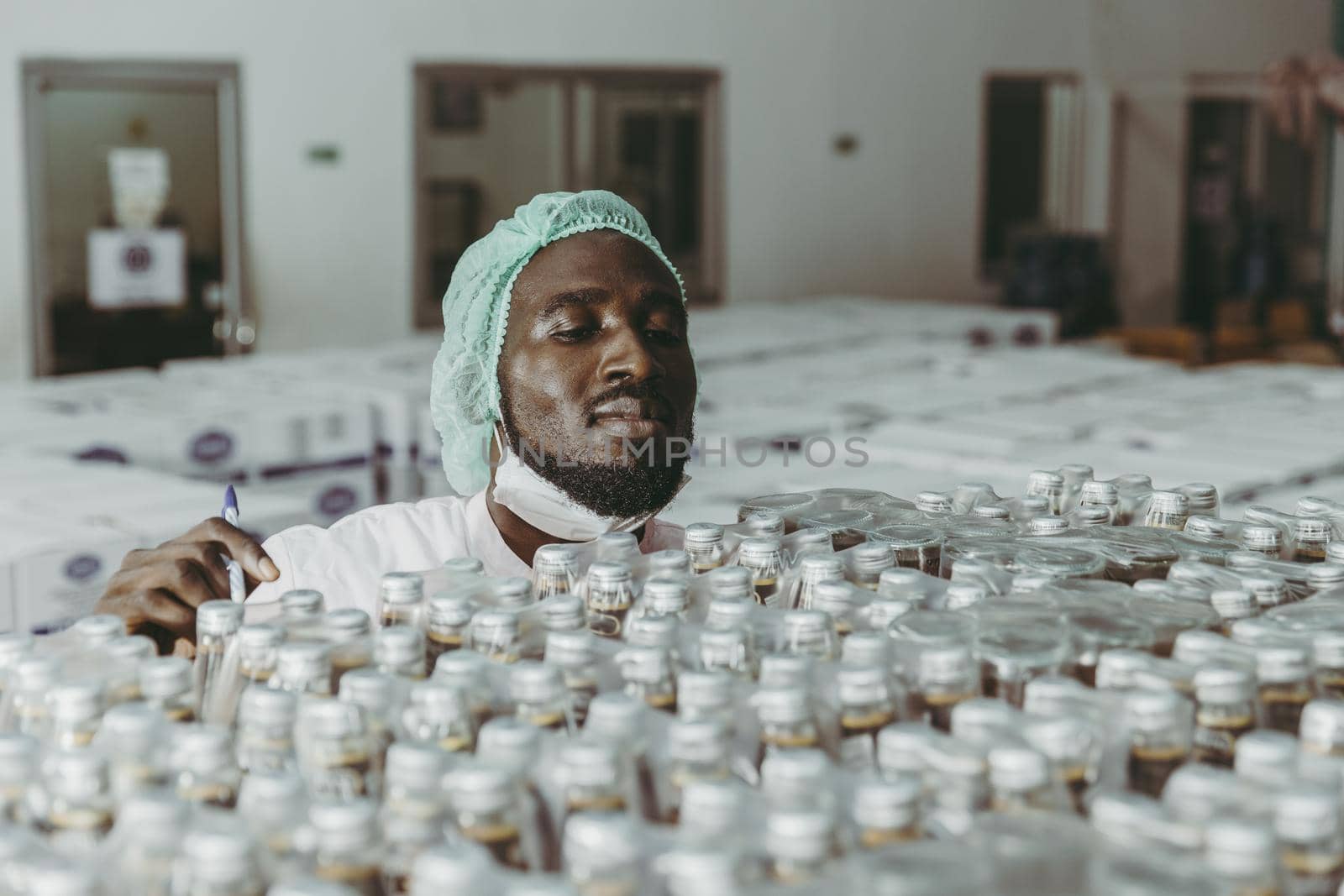Black African worker working in industry factory products checking inventory stock in the warehouse.