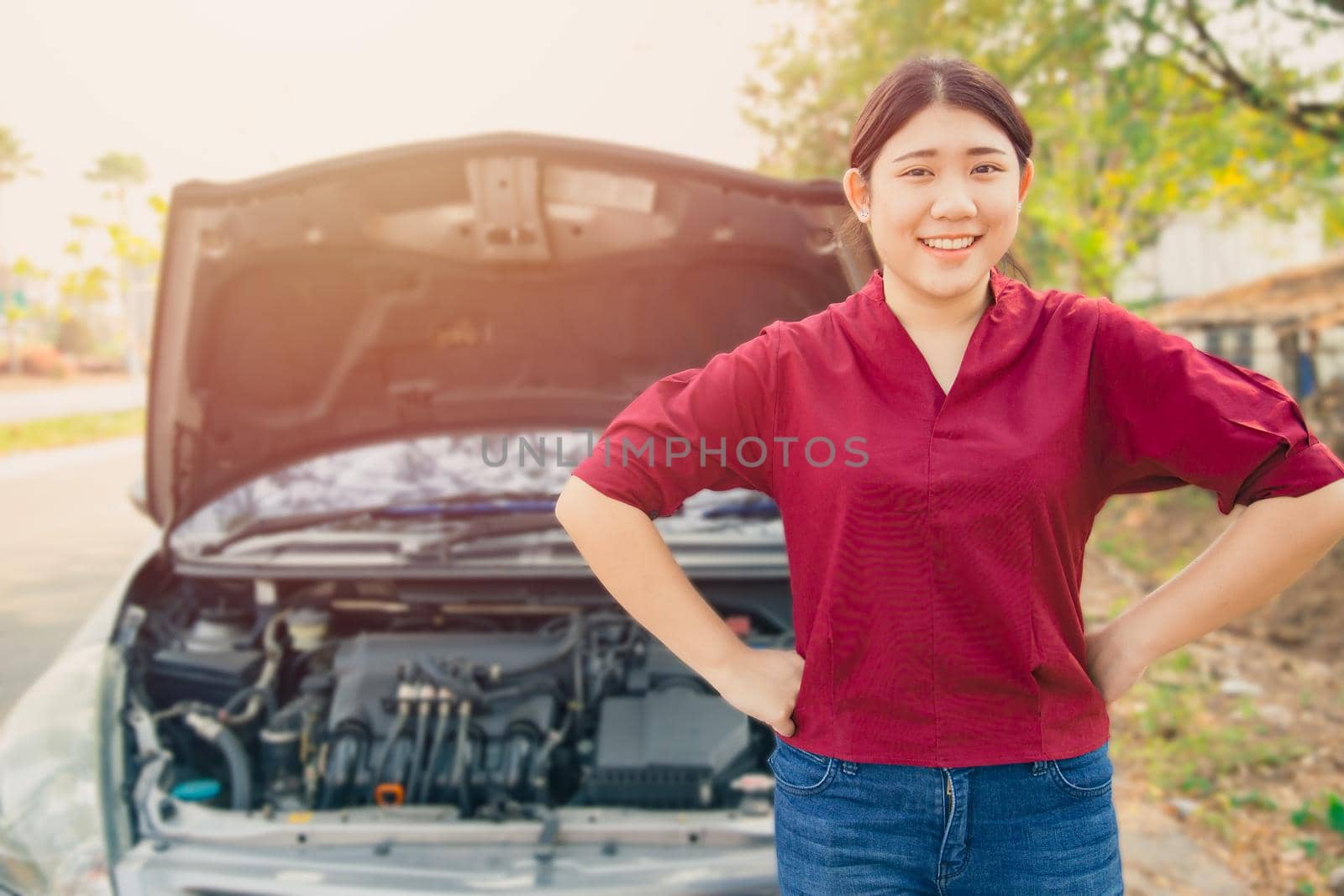 Portrait Happy women standing front of broken accidents car open hood smiling waiting car insurance at roadside with no worry. by qualitystocks