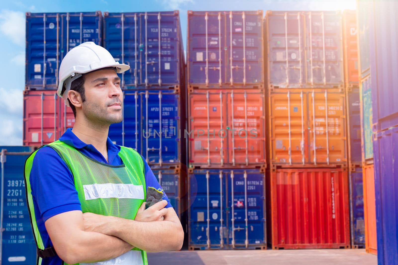 Portrait staff worker work in cargo port shipping for import export industry standing confidence.