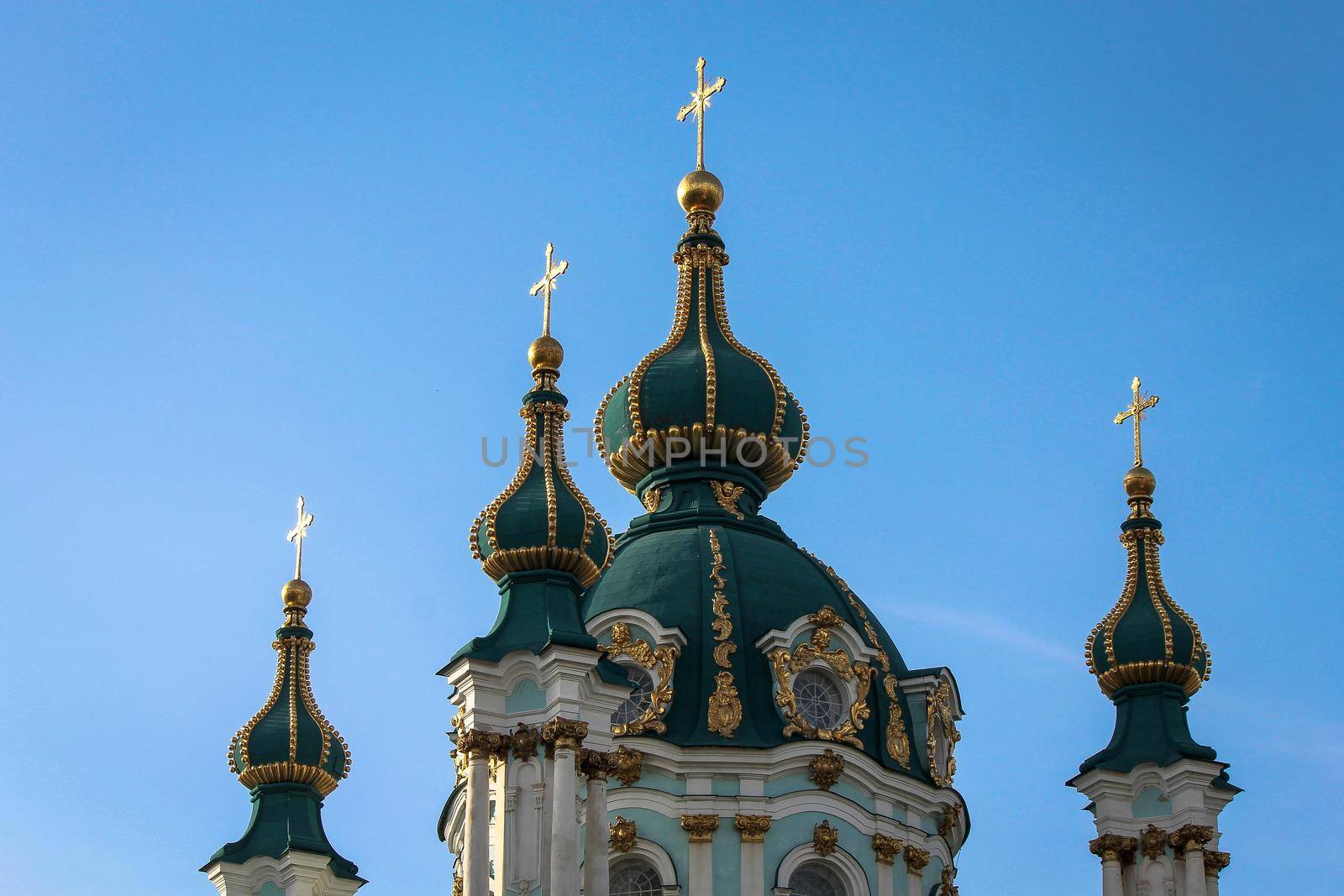 Green domes of the Kiev-Pechersk Lavra church against the blue sky. High quality photo