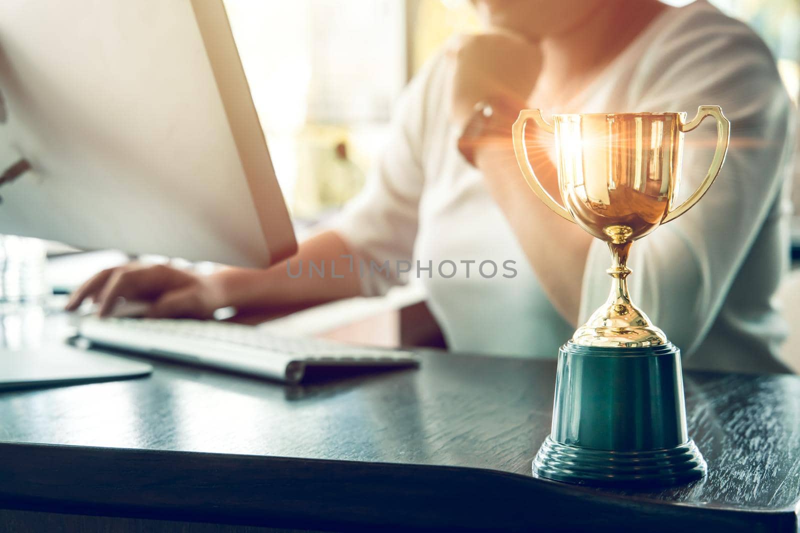 Business people working reward with golden trophy cup award to winner or champion from successful for business hard work concept. by qualitystocks