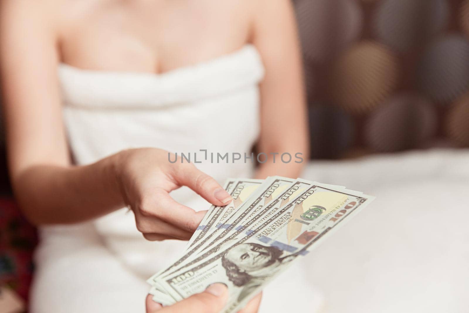 Women night worker reciving money from customer pay for personal massage service in hotel room.
