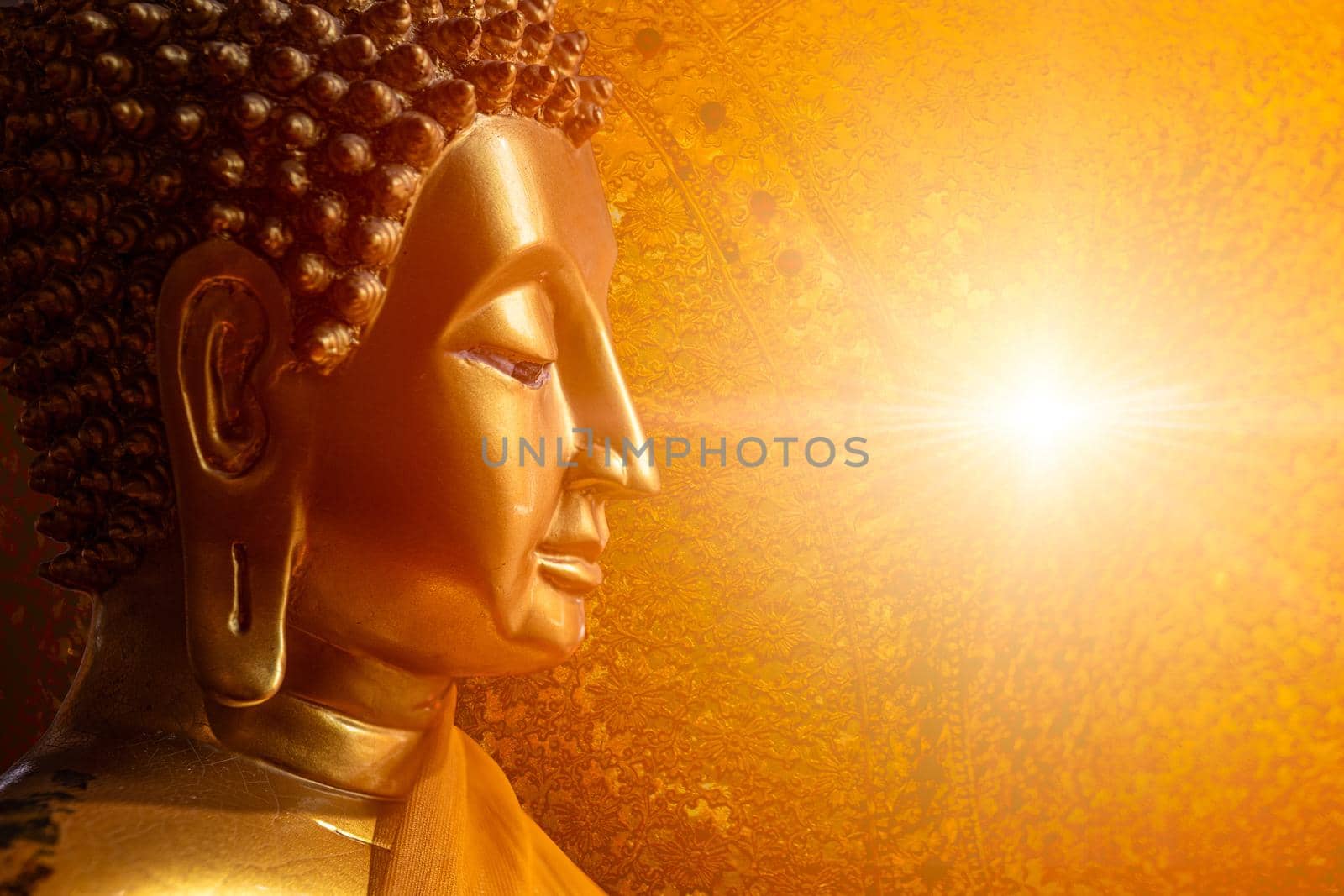 Buddha face head looking at wisdom light calm peace to nirvana way of life in Asian religion concept.