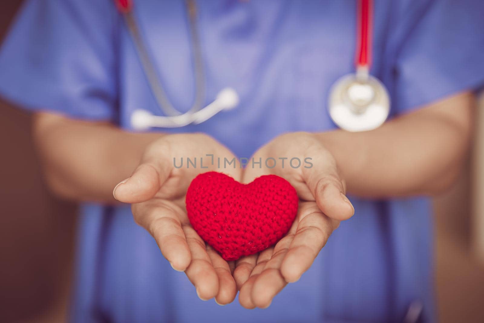 Doctor Nurse hand giving red heart for help care or blood donation healthcare share love to fight disease concept. by qualitystocks