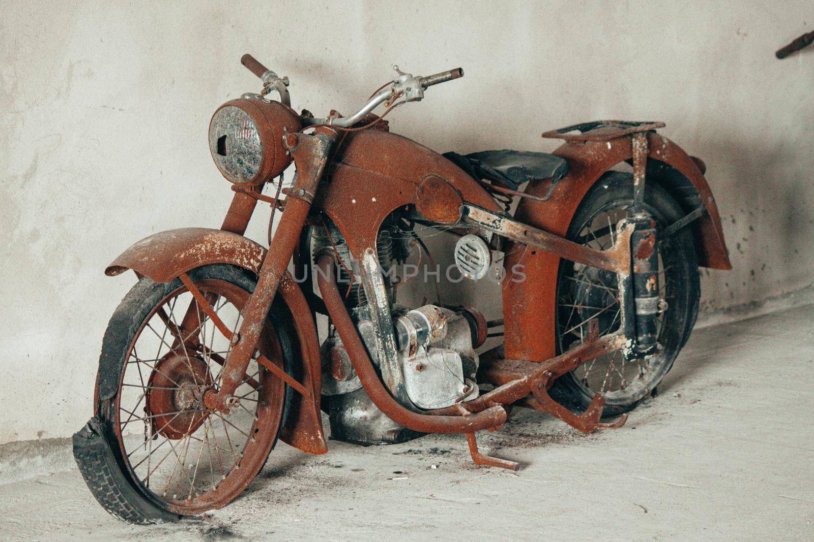 Vintage fully rusty motorcycle with torn tires. High quality photo