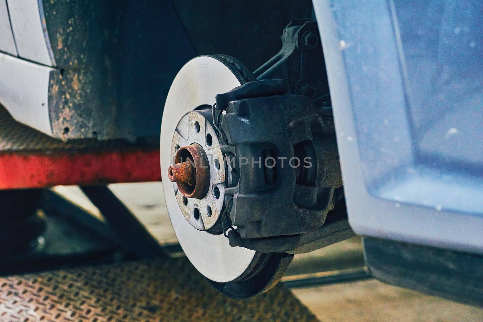 Replacing a car wheel at a tire station. a rubber covering, typically inflated or surrounding an inflated inner tube, placed around a wheel to form a flexible contact with the road.