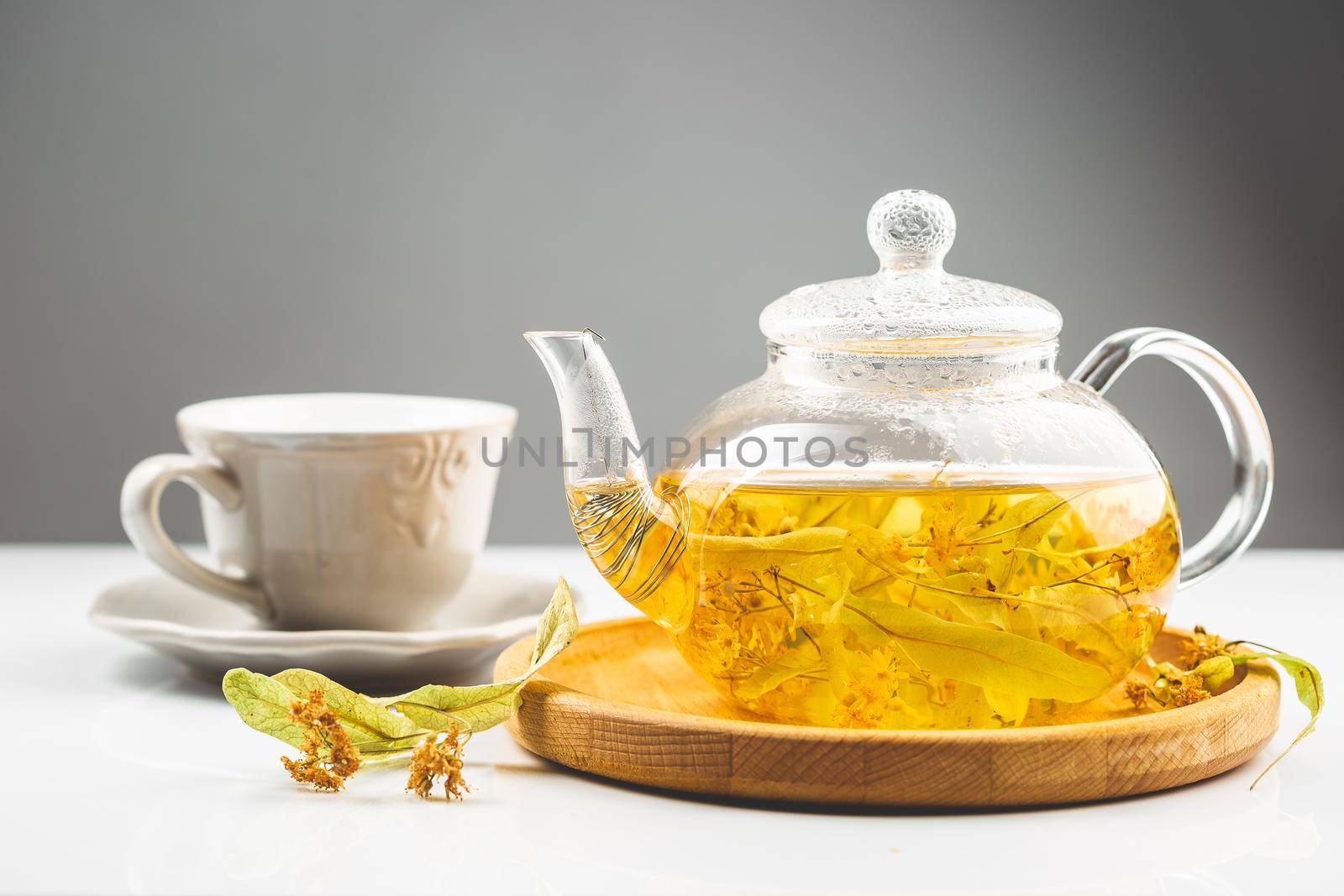 Linden or tilia flower tea in the transparent tea pot. Linden is an alternative medicine plant used in herbalism