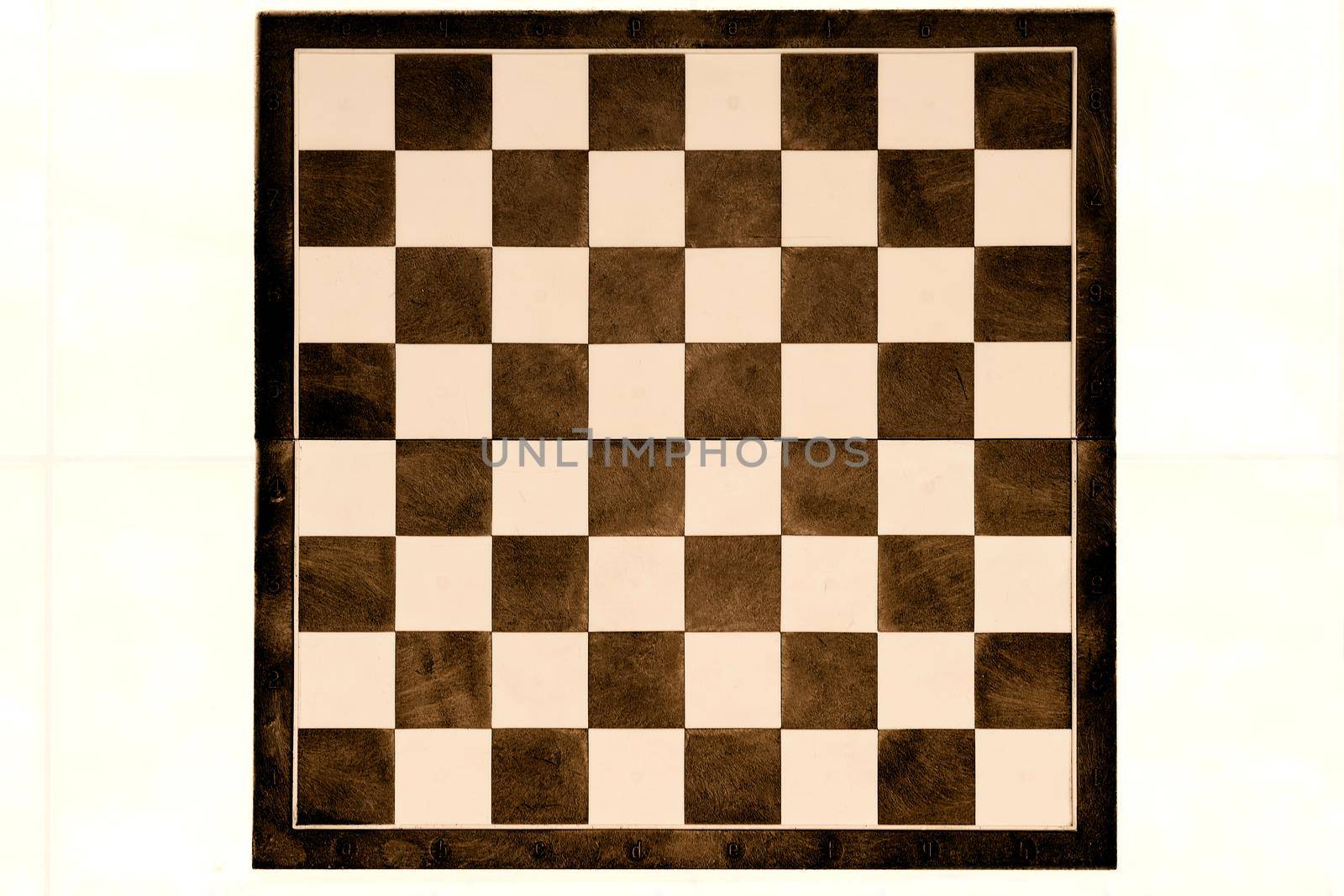 a square board divided into sixty-four alternating dark and light squares, used for playing chess or checkers.
