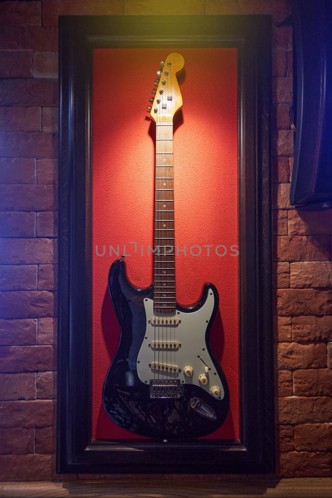 Electric guitar hanging on the wall in the restaurant for decoration.