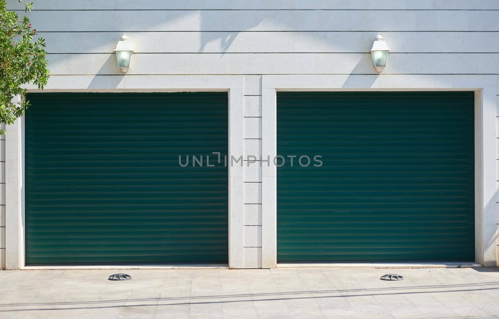 Garage with automatic rolling gates for two cars.