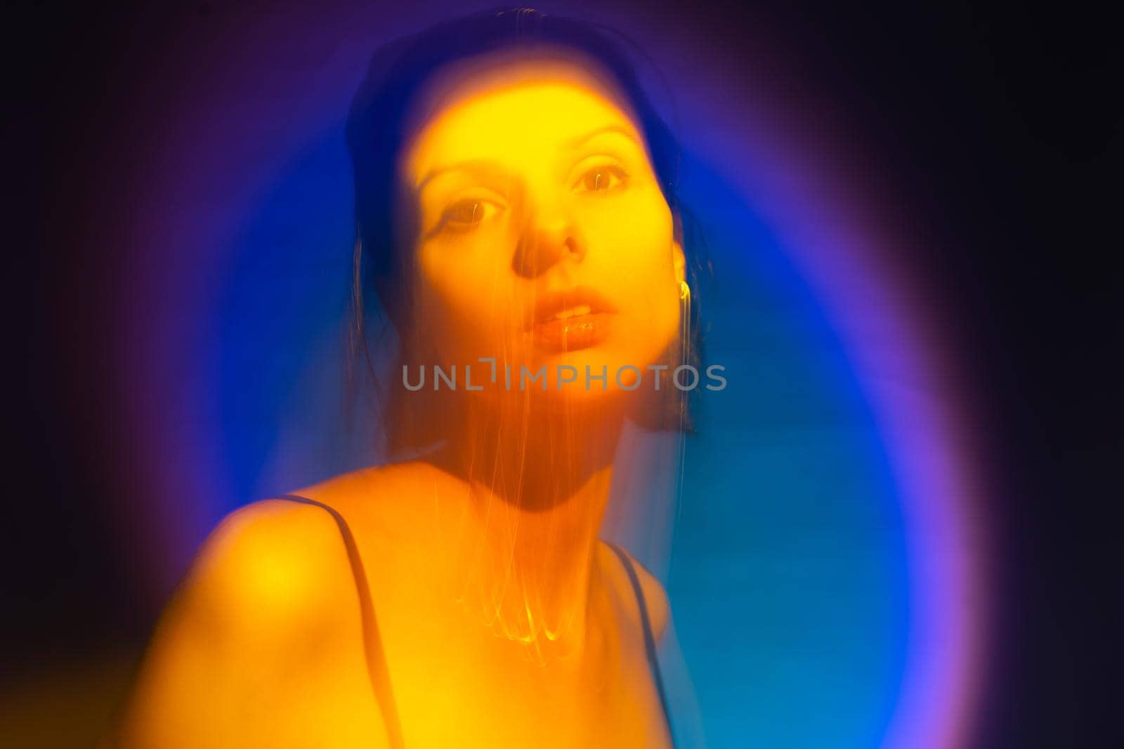 woman with a crown on her head in yellow light, art portrait. High quality photo