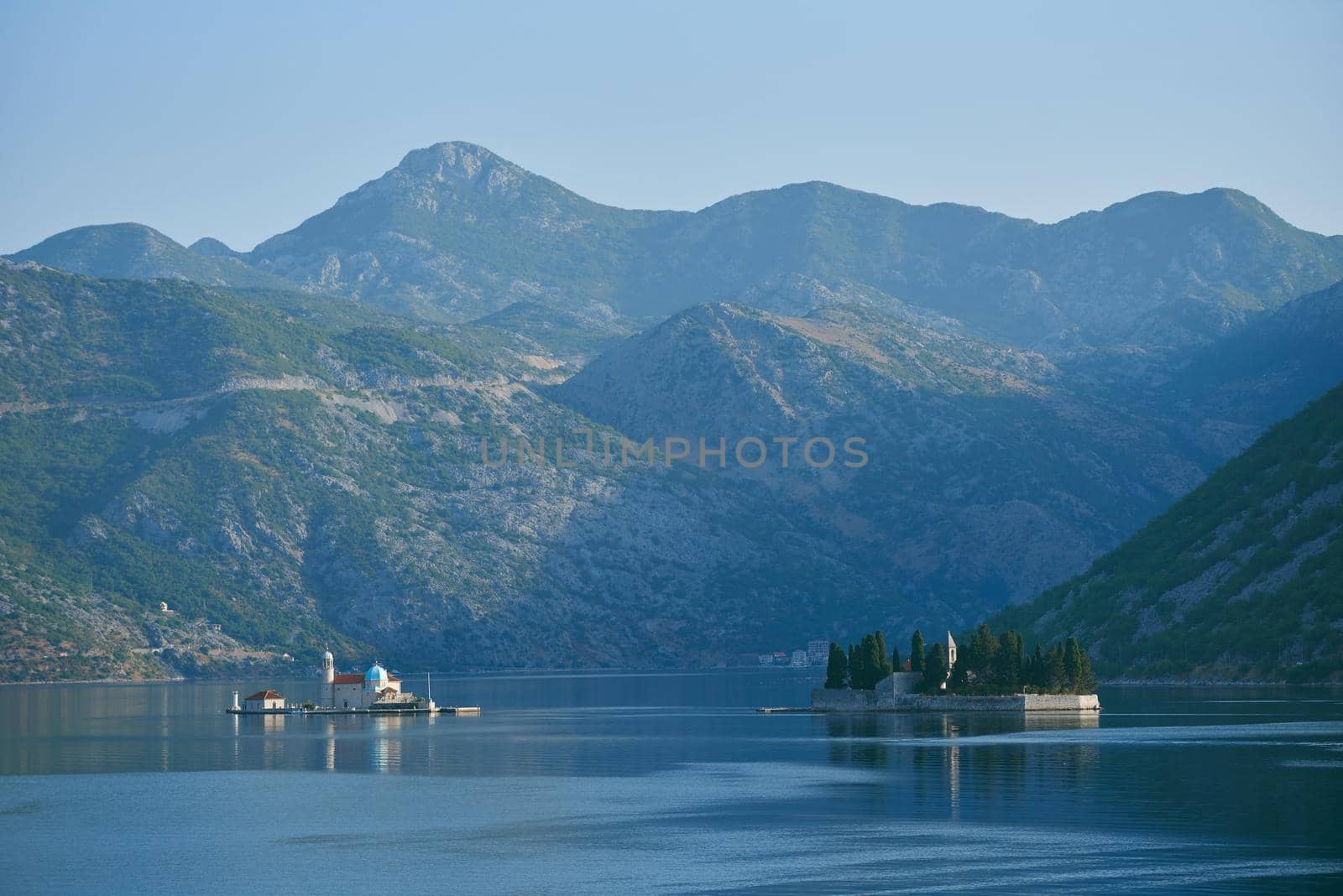 Two islands in the sea with mountains in the background in Montenegro, Perast by iceberg