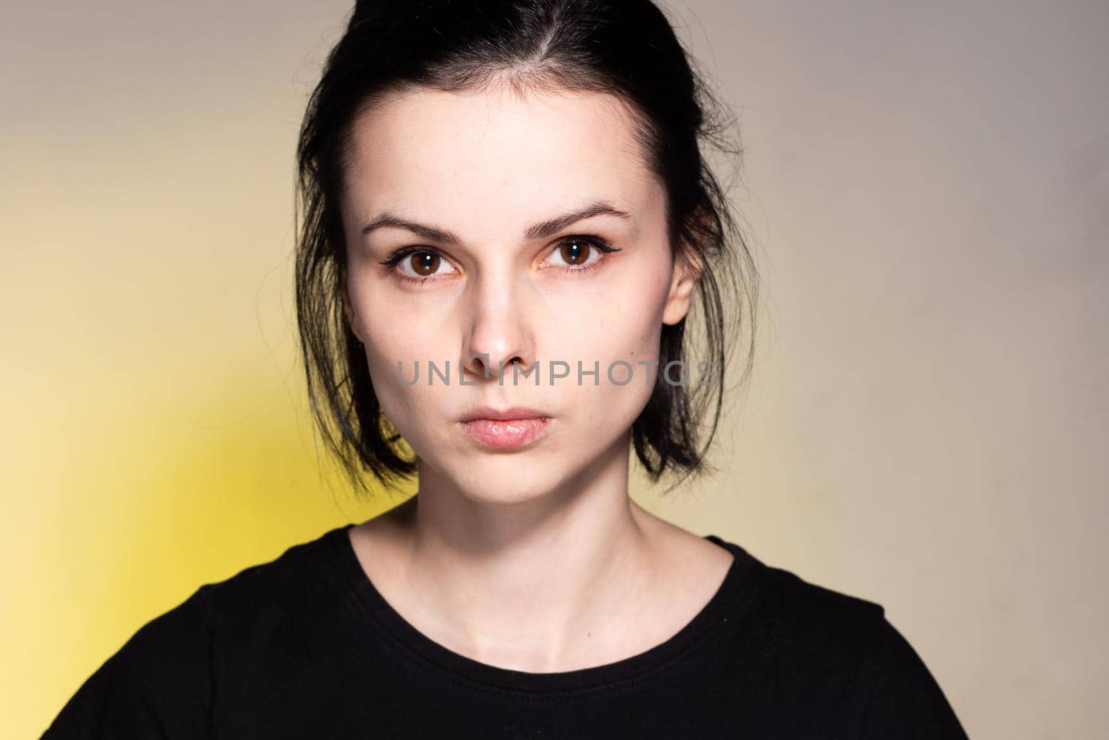 woman in black t-shirt on yellow background. High quality photo