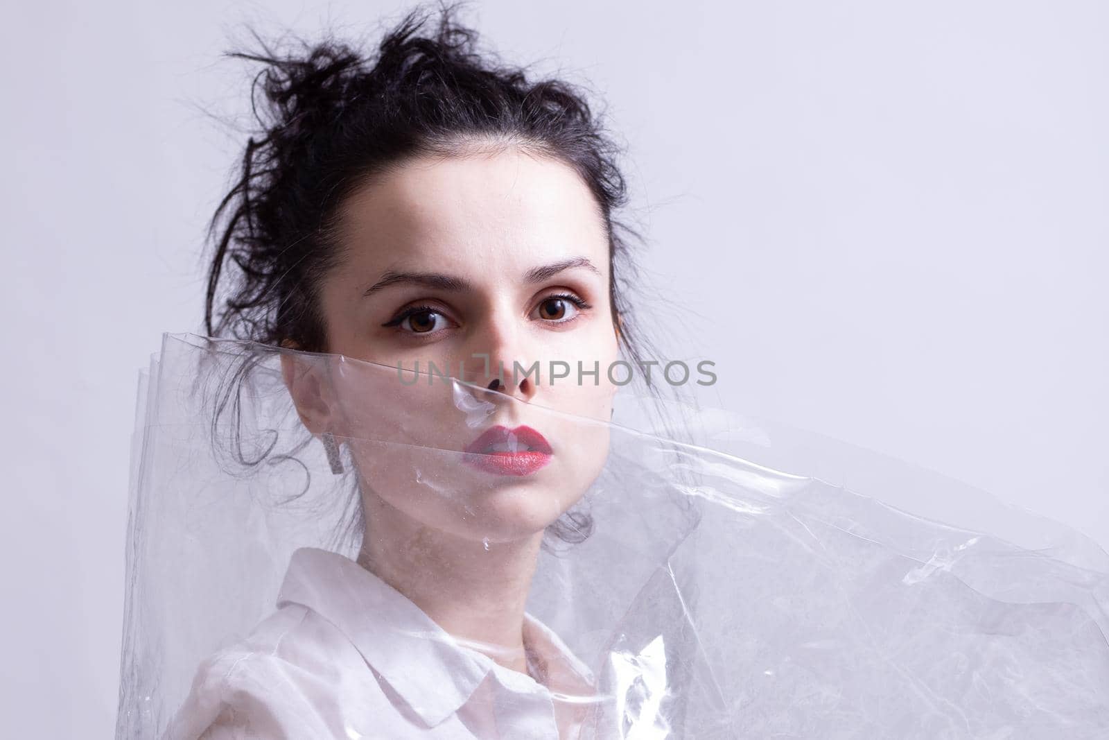 woman with red lips wrapped in plastic wrap. High quality photo