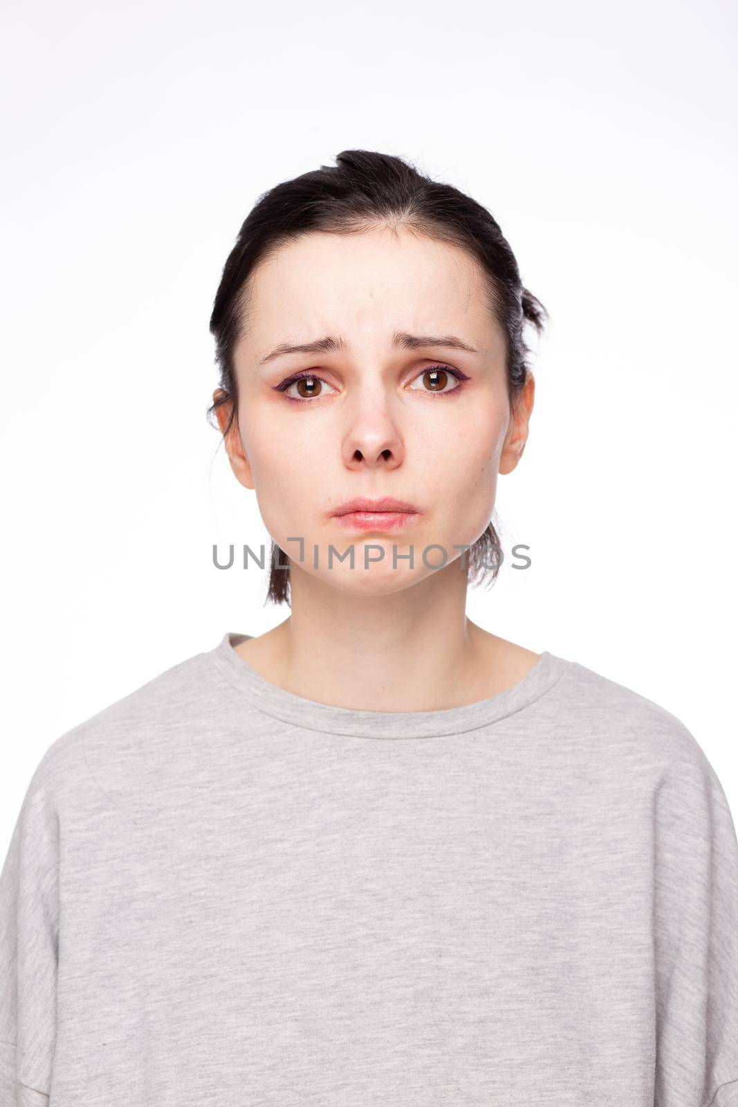 emotional woman in a gray sweatshirt, white background by shilovskaya