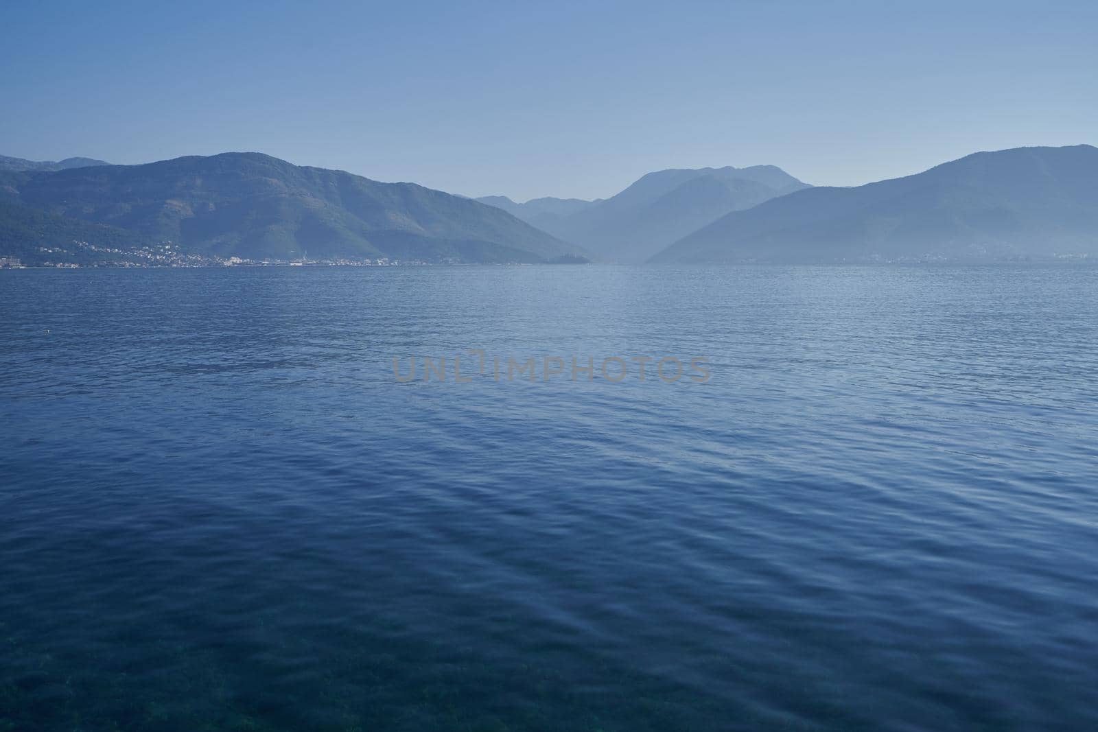 Morning seascape with mountains in adriatic sea in Montenegro.
