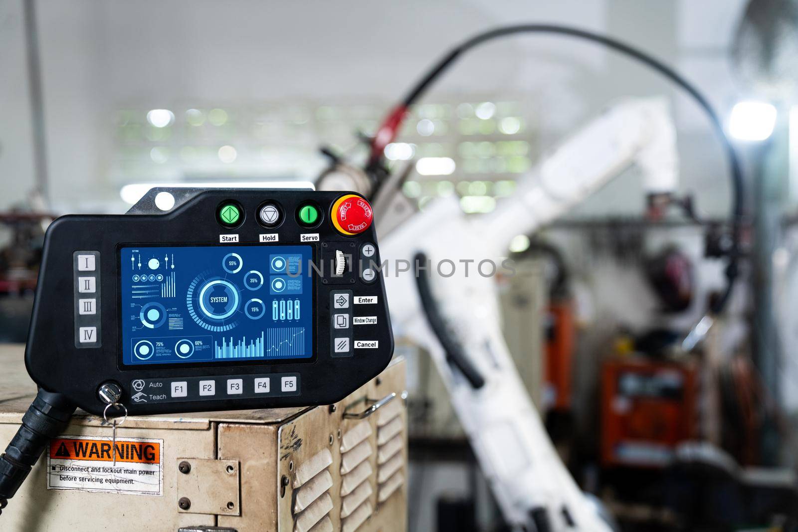 Robotic arm and its controller adept panel in a factory workshop . Industry robot programming software for automated manufacturing .