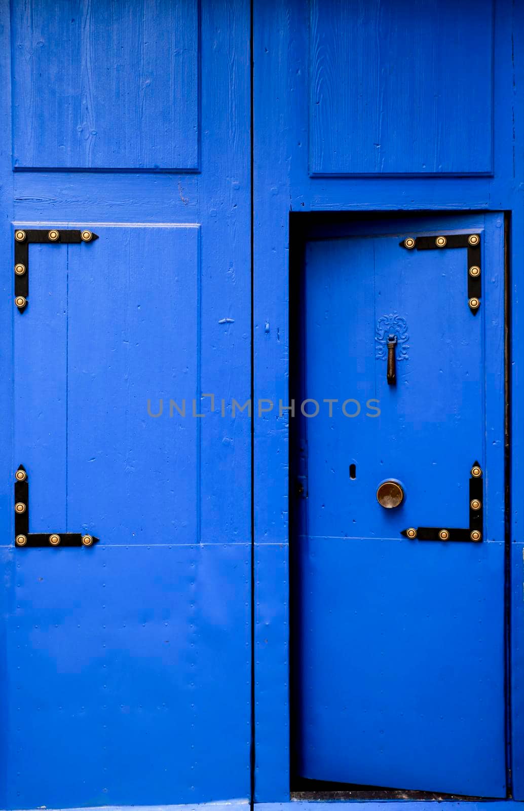 Blue wooden door with beautiful vintage knocker by soniabonet