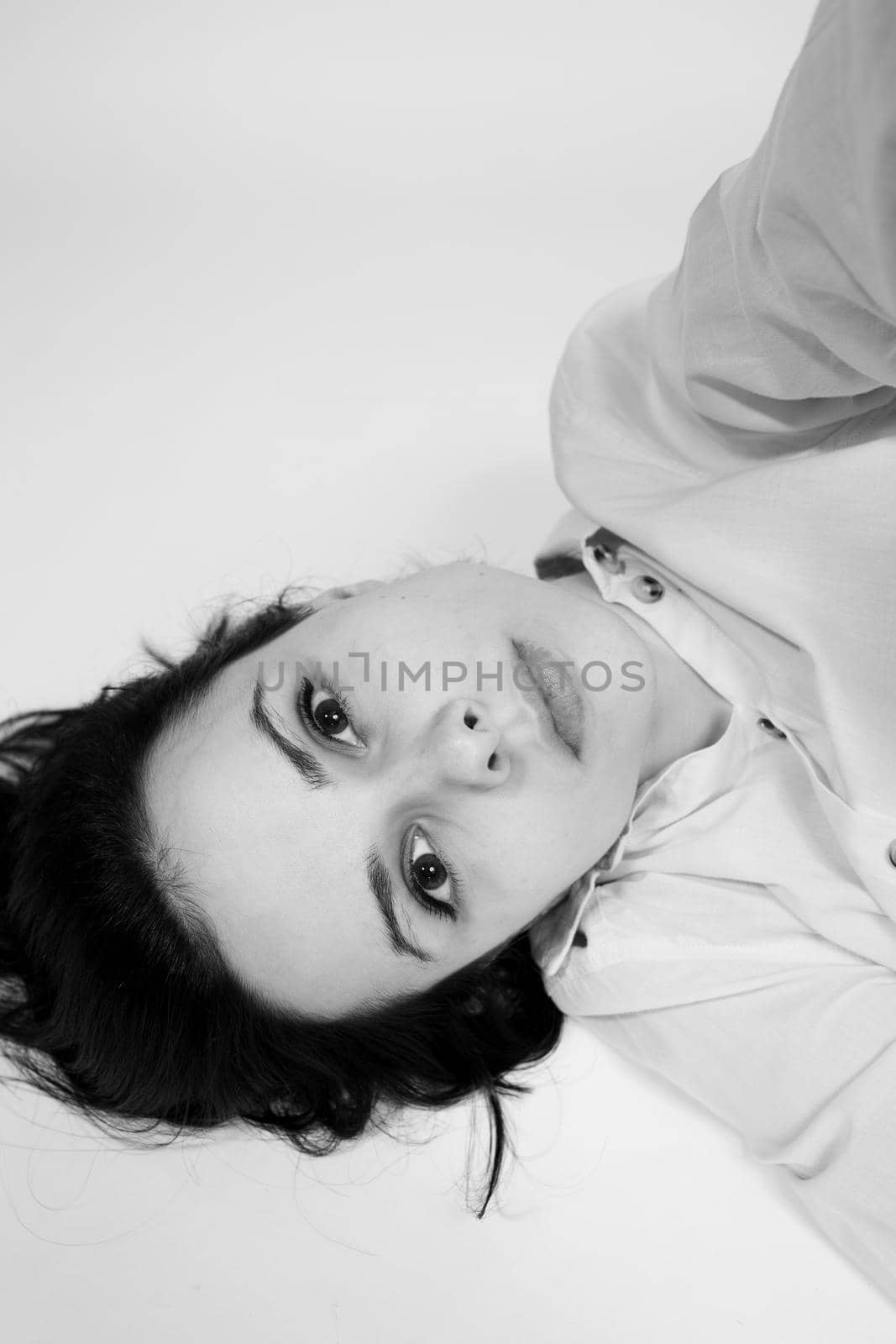 brunette woman lies on the floor, black and white photo. High quality photo