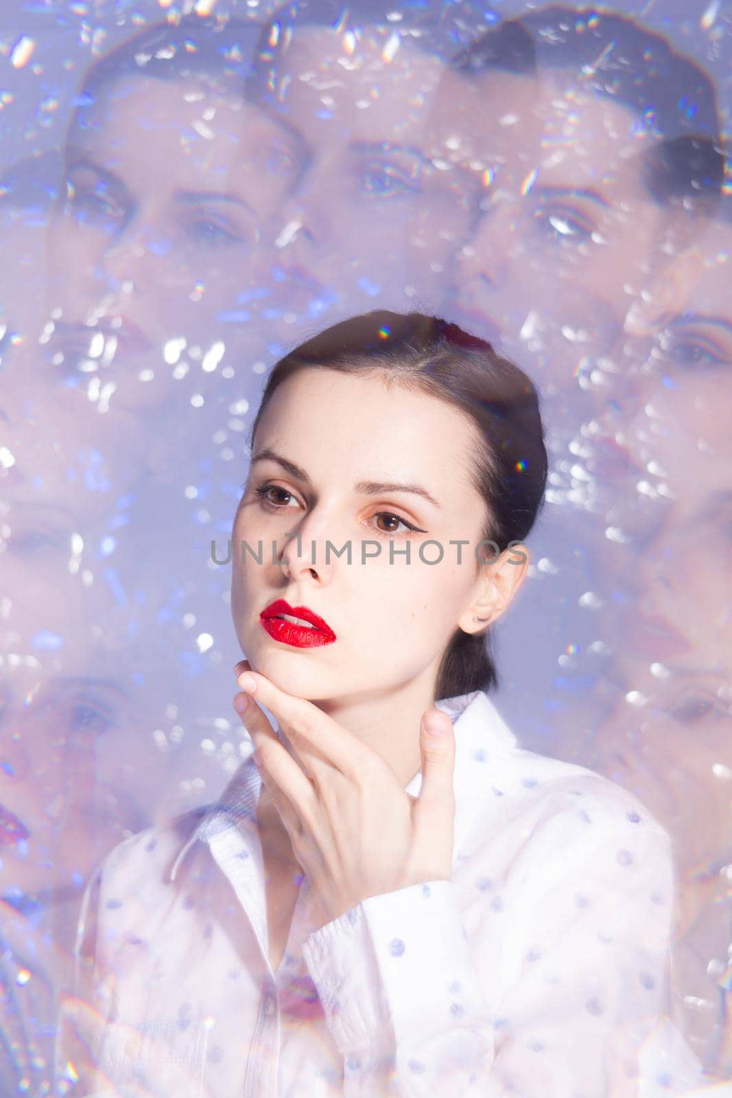 art portrait of a woman with red lipstick on her lips in a white shirt. High quality photo