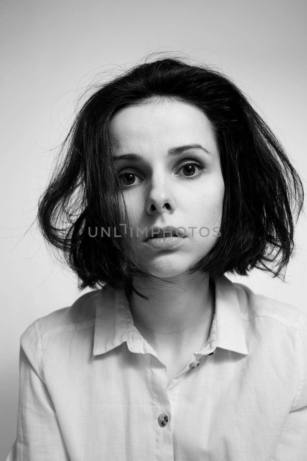 woman in a shirt, light background black and white photography. High quality photo