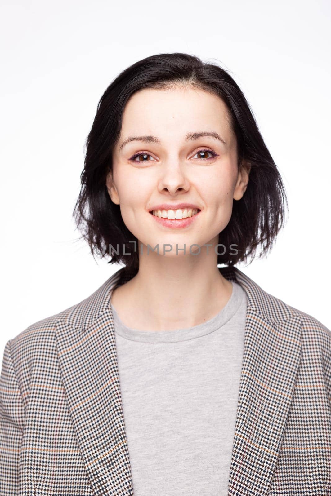 emotional woman in a gray t-shirt and jacket, white background. High quality photo