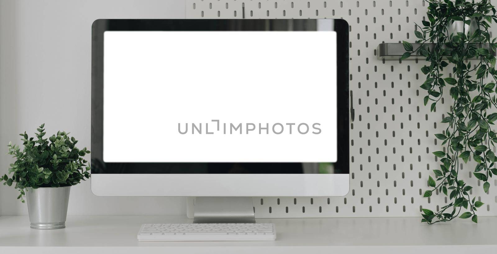Mockup blank screen laptop on desk. Workspace with laptop and office supplies..