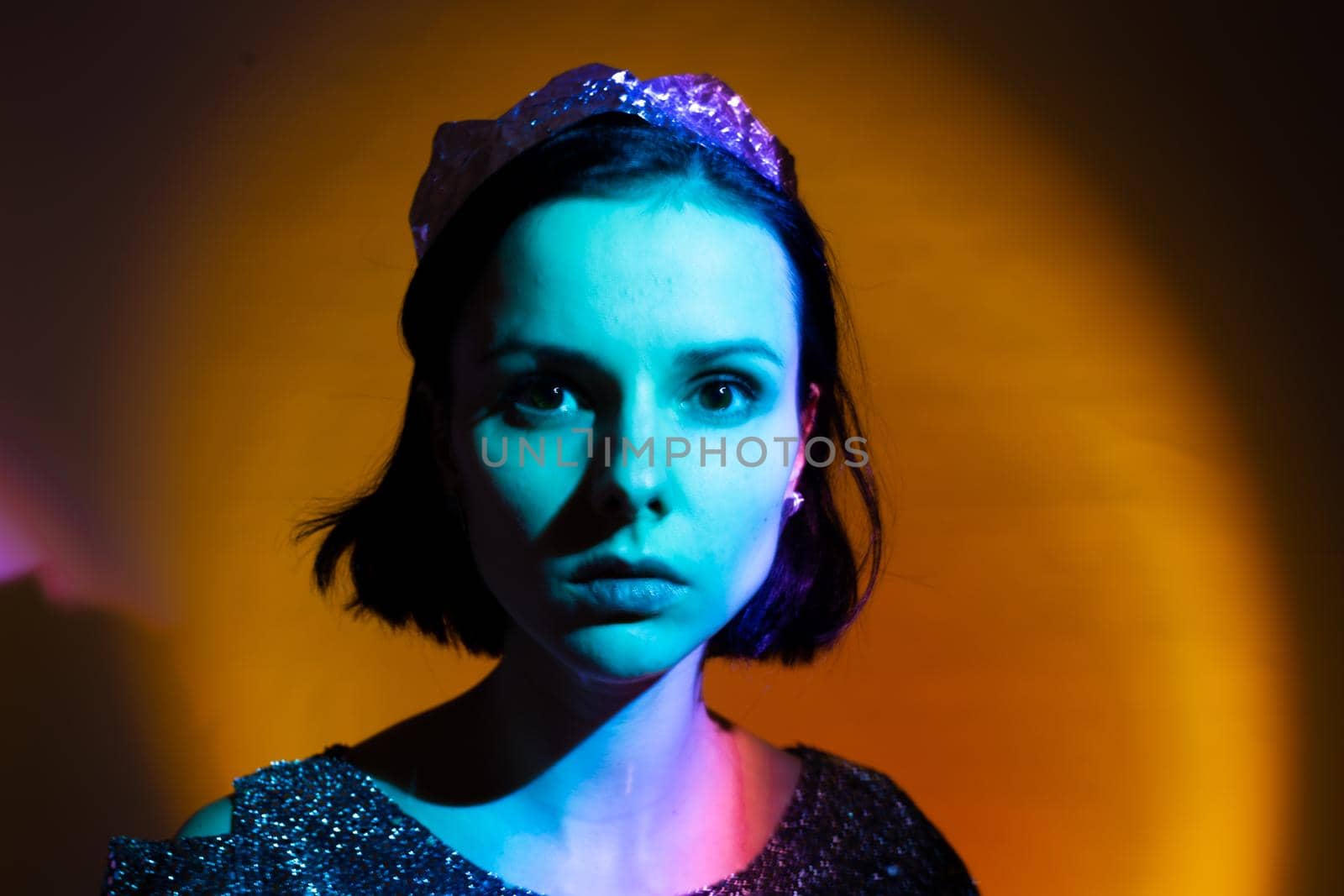 art portrait of a woman with blue light on her face, yellow background. High quality photo