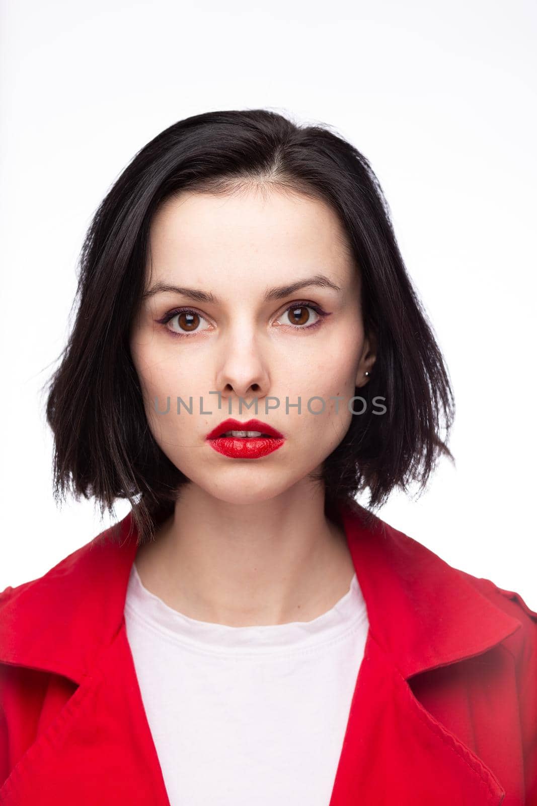 brunette woman in white t-shirt, red jacket. High quality photo