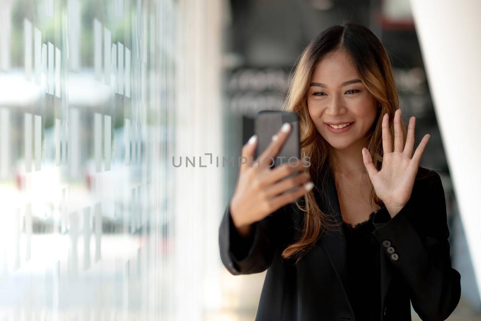 Beautiful asian woman using smartphone, exciting and celebrating with good news of business successful. Small business startup concept..