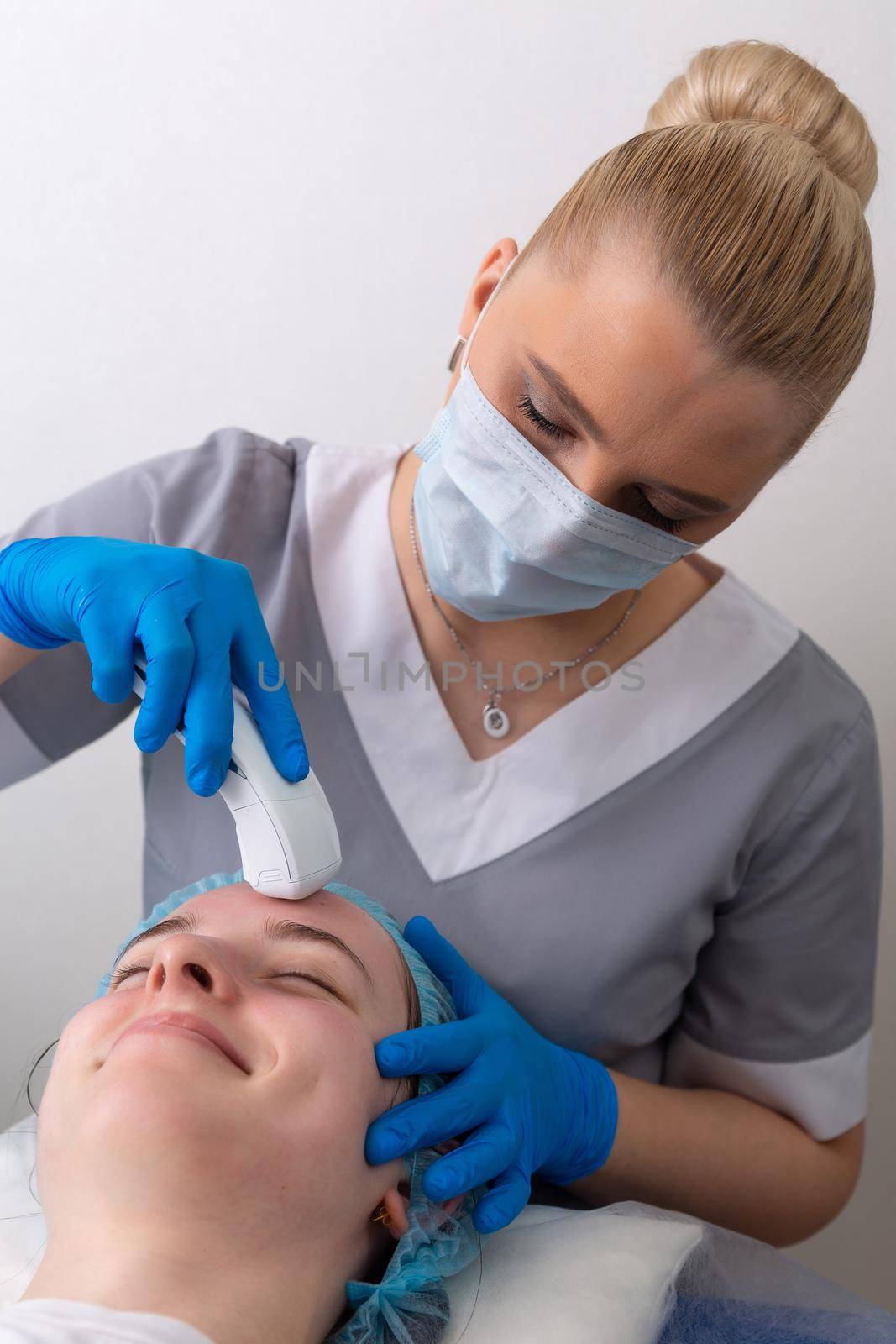 Young woman receiving electric galvanic anti-aging face spa massage at beauty salon. Galvanic massage helps to speed up metabolism, improve regeneration and restore skin protection from harmful external factors.